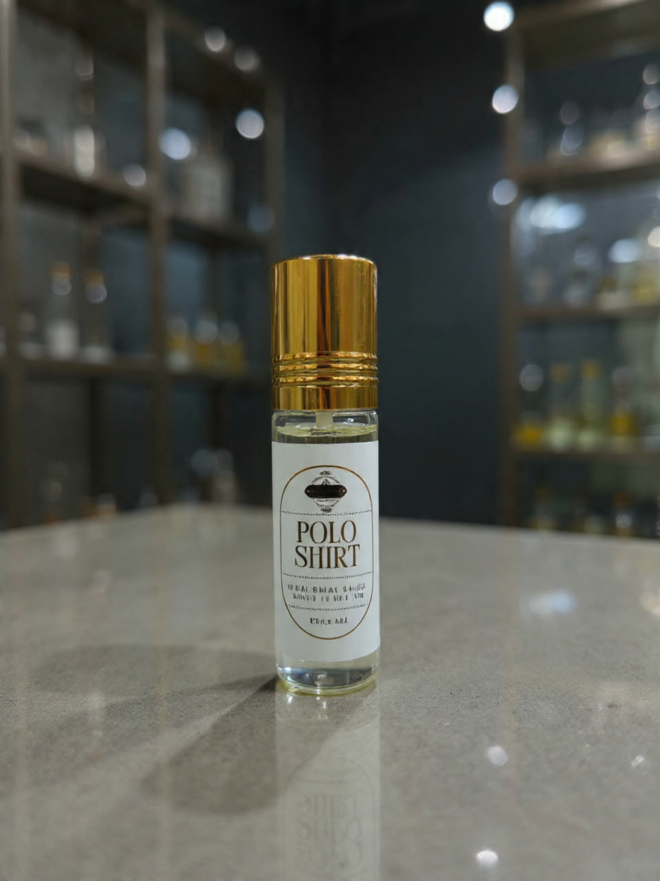 Small bottle of Polo Shirt cologne with a gold cap on a reflective surface.