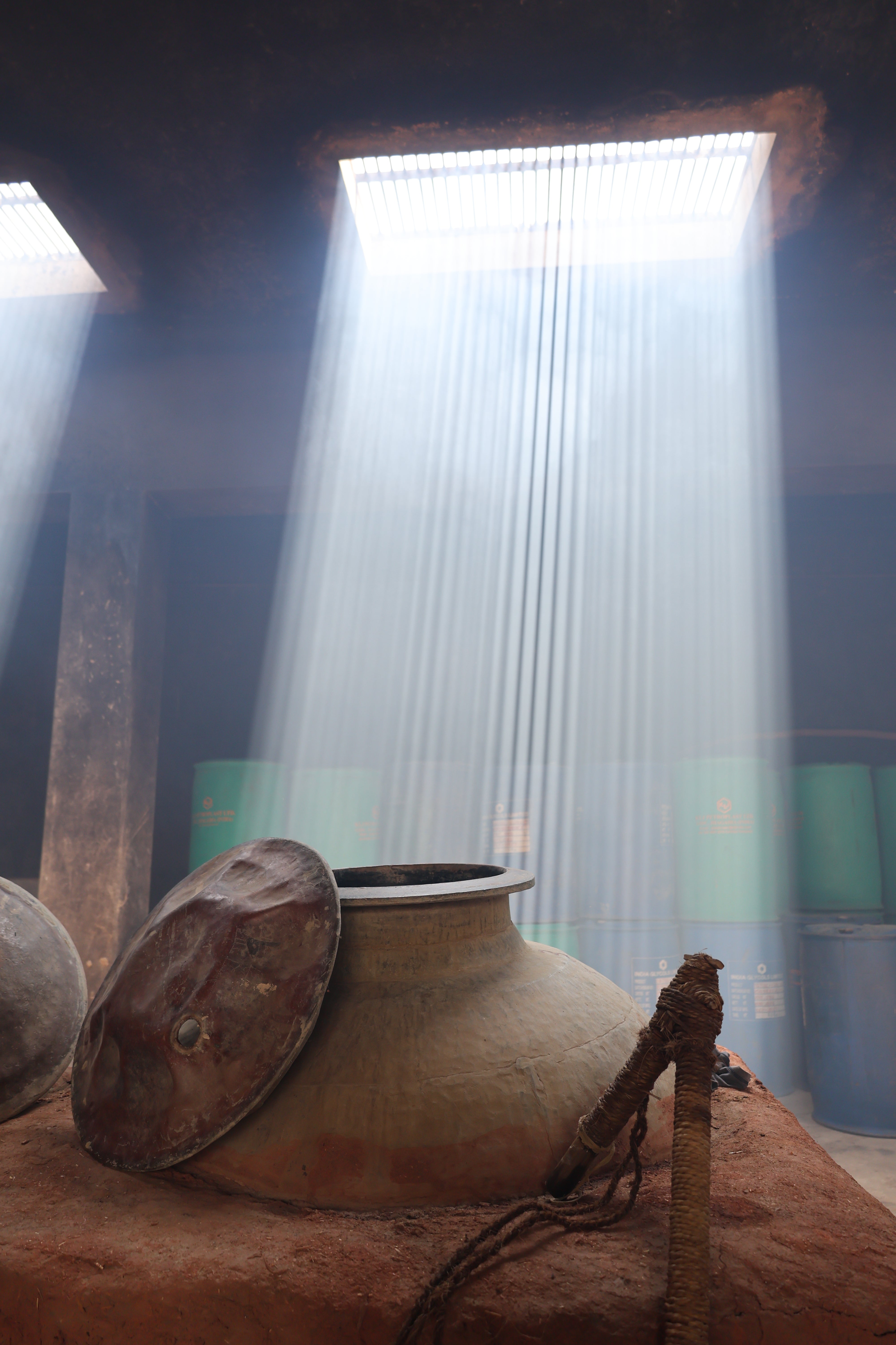 Hari Bhai at the workshop — light beam over the copper deg, Kannauj