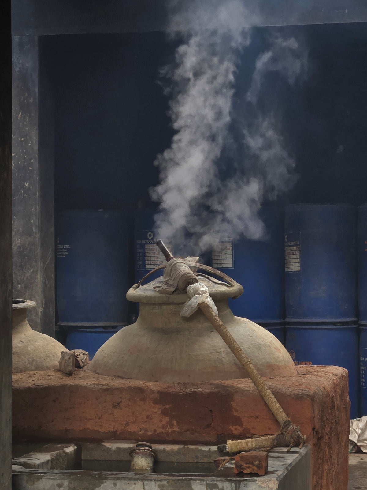 Traditional copper bhapka containing sandalwood oil receiving botanical steam in Kannauj
