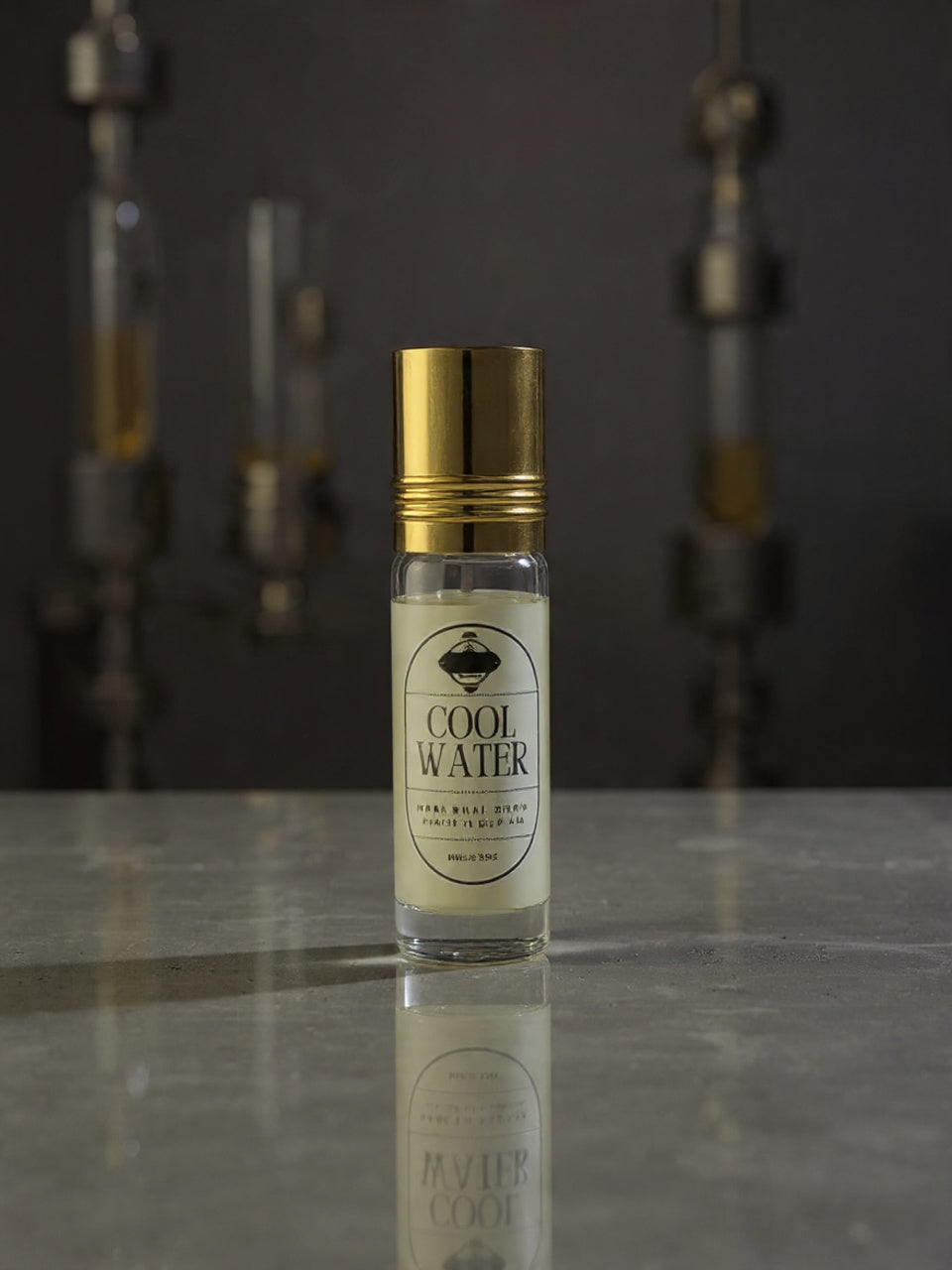 Small bottle of 'Cool Water' cologne with gold cap on a reflective surface.