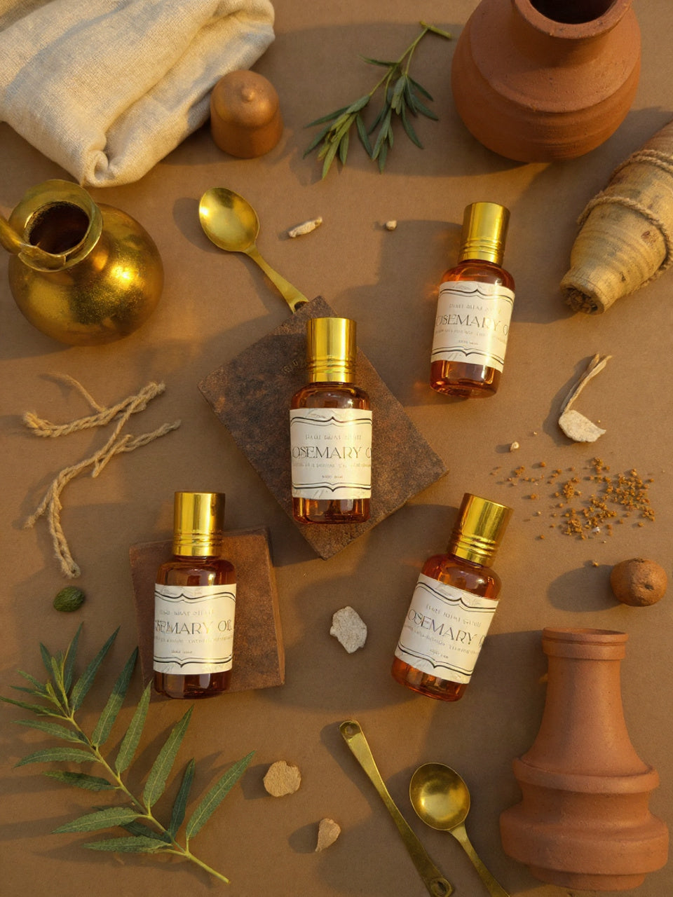 Rosemary oil bottles with labels on a rustic background with olive branches and containers.